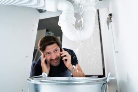 man looking at leak